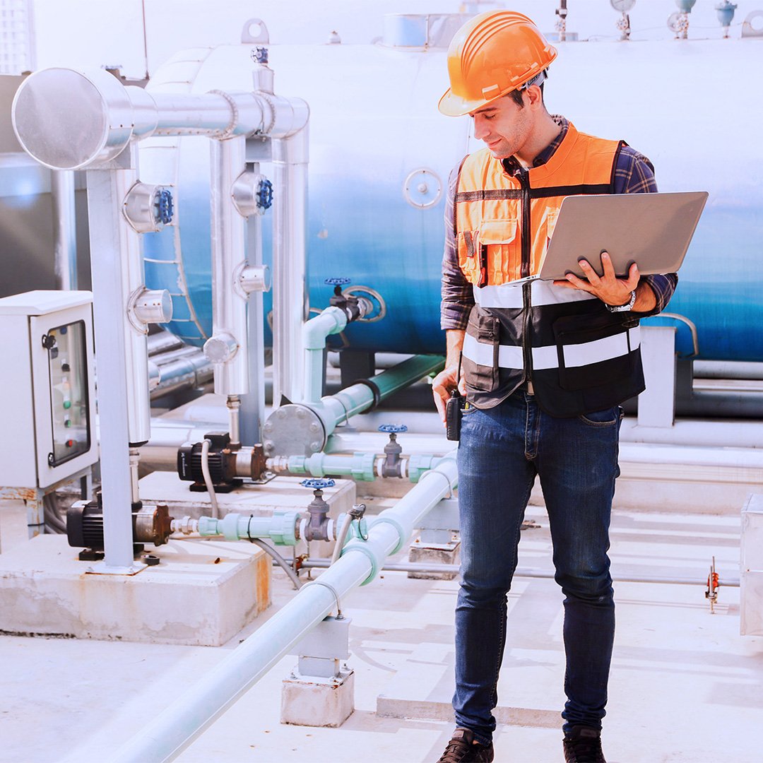HVAC-technician-with-laptop-on-roof-of-building-SQUARE