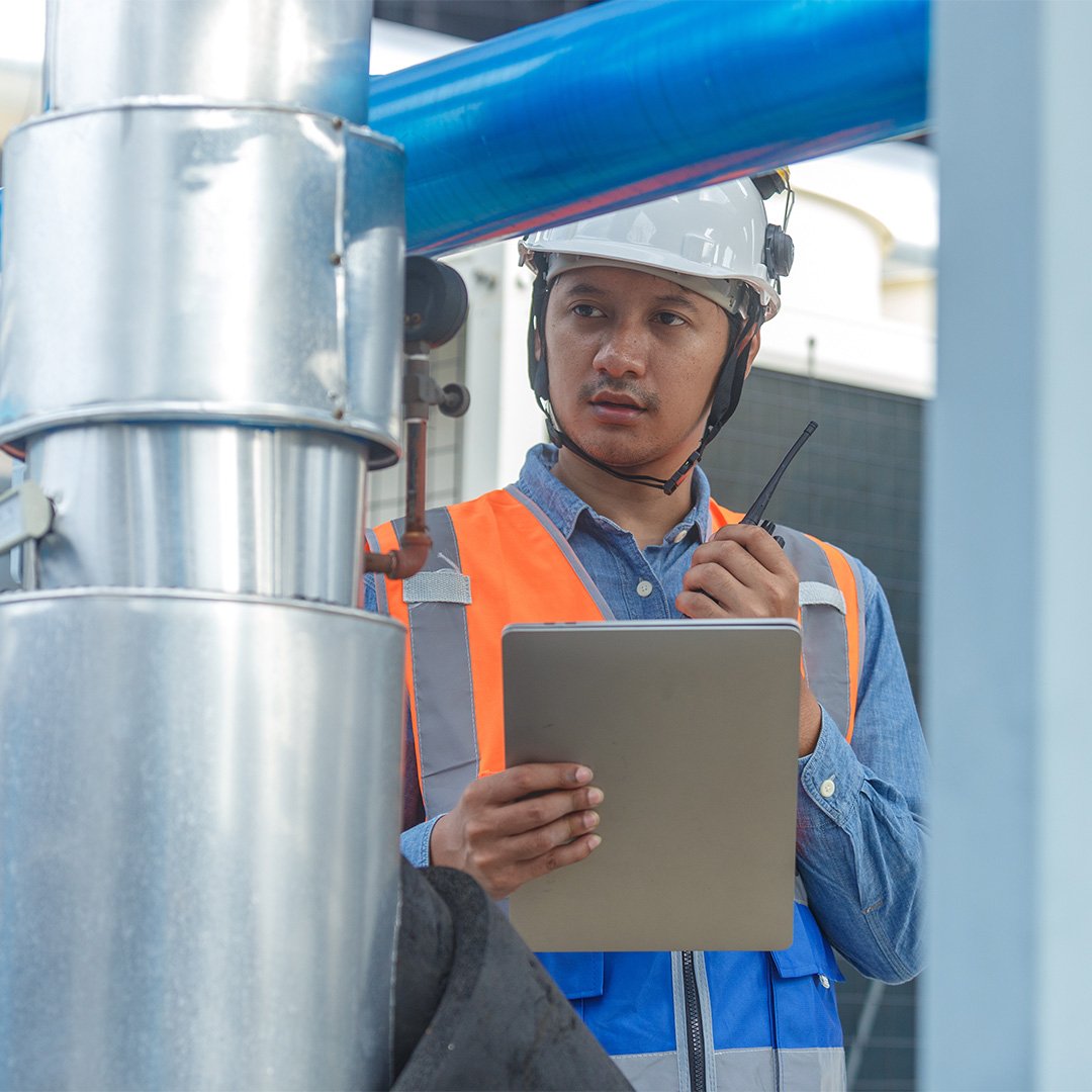engineer-on-walkie-talkie-with-ipad-checking-HVAC-air-quality