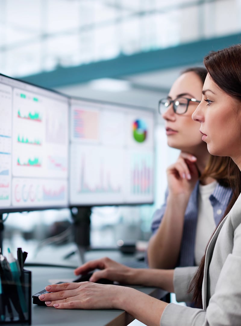 female-colleagues-analze-data-on-screen