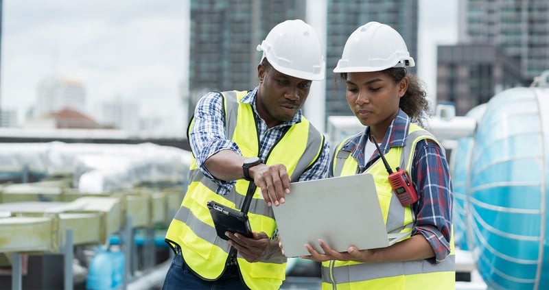 two-HVAC-technicians-identifying-refrigerant-problem-on-laptop
